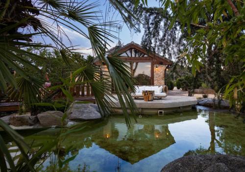 a resort with a pool and a pavilion at Villa Oasis Madrid in Batres