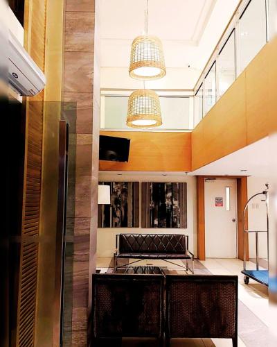 a dining room with a table and two chairs at Cozy 1BR with City View, Beach Access and Wave Pool in Manila