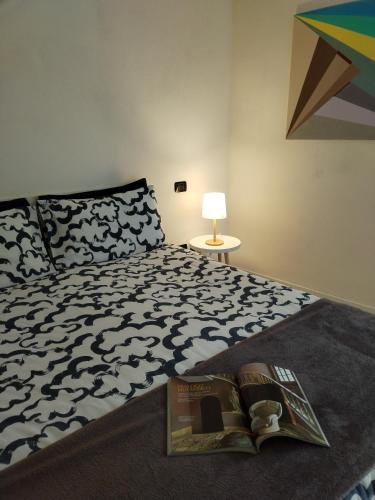 a bedroom with a bed with a book on it at un balcone sul lago in Omegna