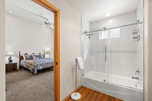 a bathroom with a tub and a bedroom with a bed at Birdie Glen Retreat - Golf course getaway with hot tub and office in McCall