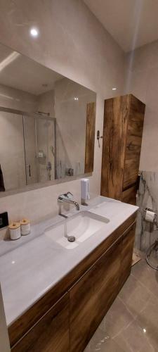 a bathroom with a sink and a mirror at Sea Breeze,Park Residents 2 by Tatyana in Baku