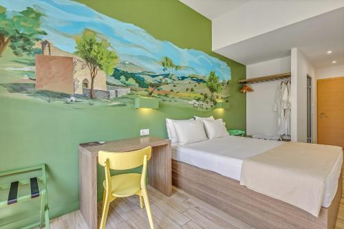 a bedroom with a bed and a desk with a yellow chair at Sofia's Lovely Rooms in Khóra Sfakíon