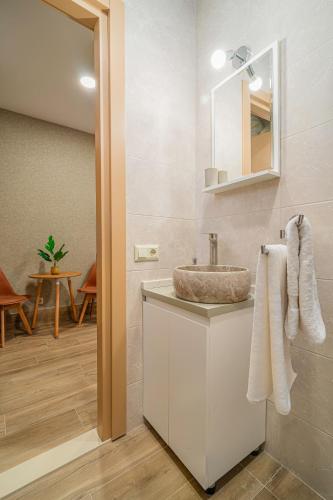 a bathroom with a sink and a mirror at Old Askana in Tbilisi City