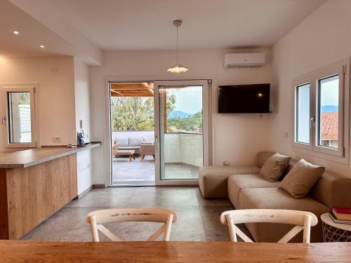 a living room with a couch and a table at Andreia in Dorgali