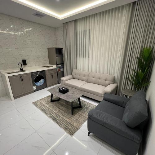 a living room with a couch and a table at Bee House in Taif