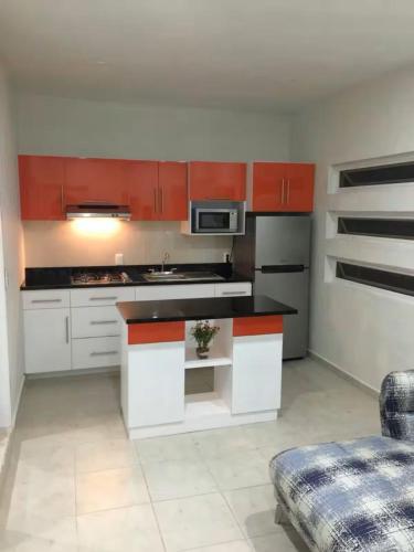 a kitchen with white cabinets and a stove top oven at Departamento "A" Fracc Cd Del Valle in Tepic