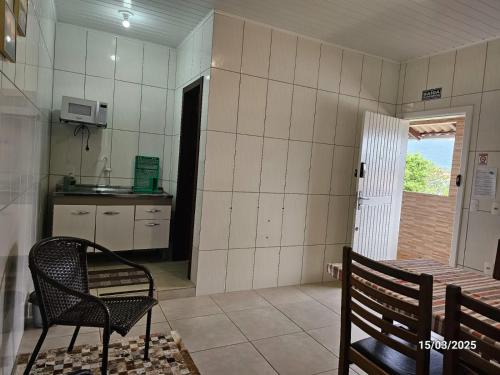 eine Küche mit einem Tisch und einem Stuhl in einem Zimmer in der Unterkunft 05 Residencial Lazzaris in Penha