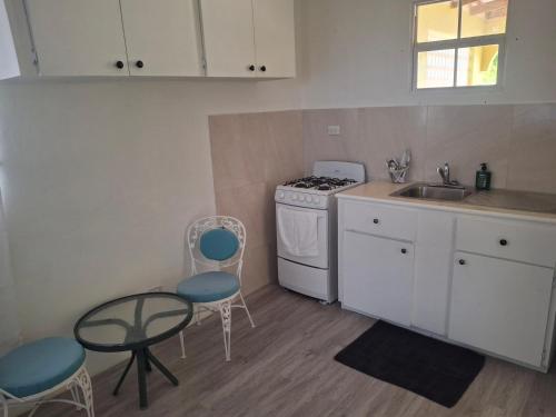 a kitchen with a sink and a stove top oven at Fair View Garden By-BLR in Christ Church