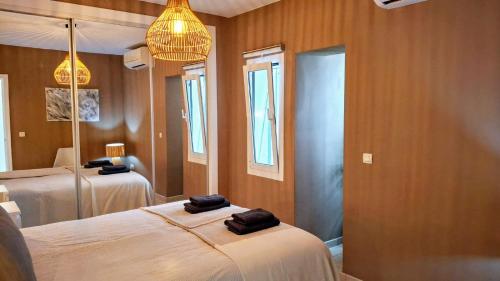 a room with two beds and two mirrors in it at Carmen Apartamento Eleanora in Nerja
