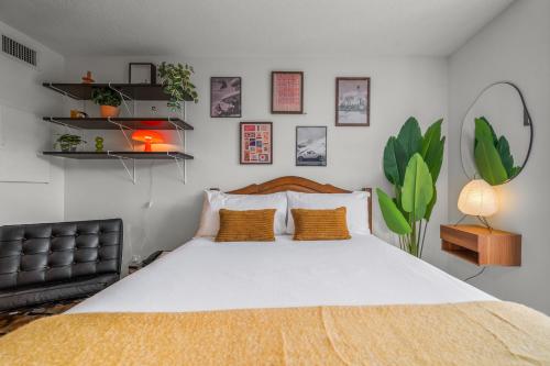 a bedroom with a large bed with yellow pillows at Mid Century Modern - Studio w Pool & Hot Tub in Whistler