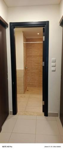 a door leading to a shower in a room at E13 Samarah Resort Apartment in Sowayma