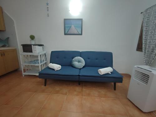 a blue couch sitting in a living room at Emadi House Porto Rotondo in Porto Rotondo