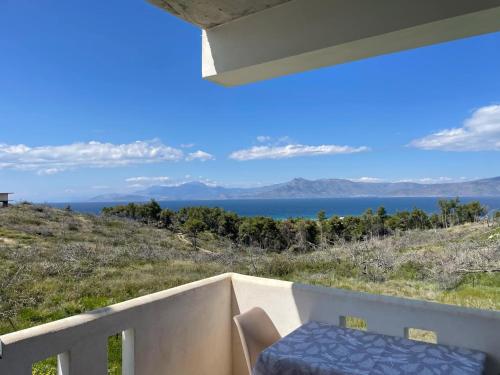 a porch with a bench and a view of the ocean at MirSea - Luxury stay Alepochori in Megara