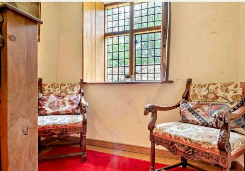 a living room with two chairs and a window at Beautiful Brecon Beacon House in Llandovery