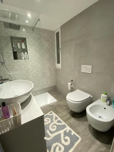 a bathroom with a white sink and a toilet at Hope House in Villasimius