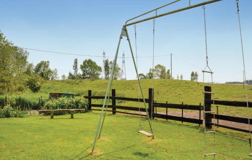 an empty swing in a yard with a hill at Lovely Home In Hames Boucres With Wifi in Hames-Boucres
