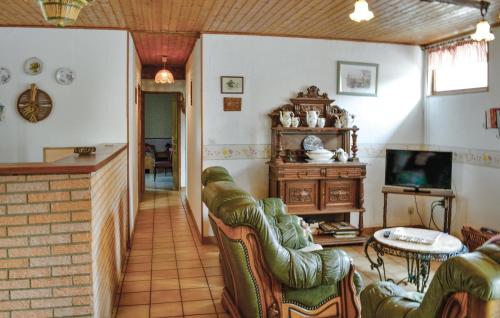 a living room with leather chairs and a television at Lovely Home In Hames Boucres With Wifi in Hames-Boucres