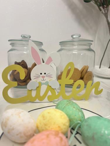 a sign with a bunny on it next to jars of donuts at Guest House Esty in Rome