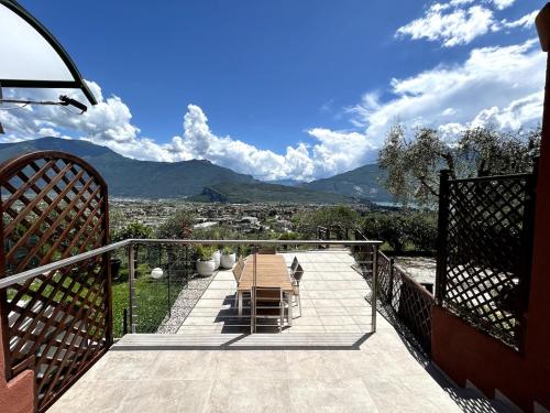 a balcony with a table and a view of the mountains at BonBon Dom Lake View in Varone