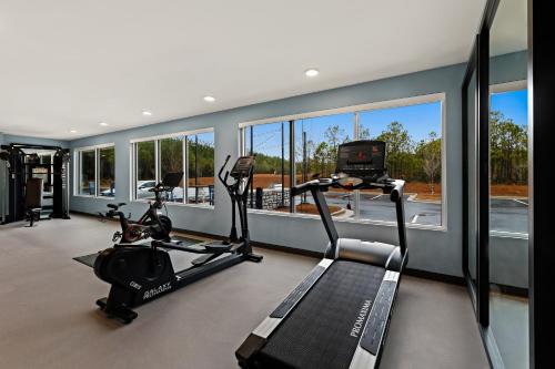 a gym with two treadmills and a treadmill at Everhome Suites Brownsville in Brownsville