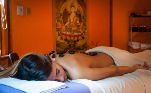 a woman laying on a bed with sunglasses on her face at Hotel Boutique Refugio El Molle in El Molle
