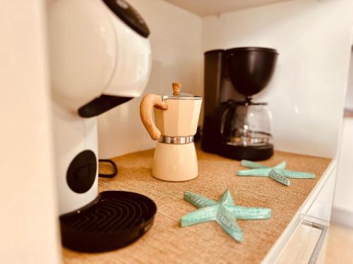 a kitchen counter with a coffee maker and stars on it at Canela Tenerife Apartment in Puertito de Güímar