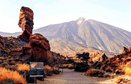 a mountain in the desert with a sign in the foreground at Canela Tenerife Apartment in Puertito de Güímar