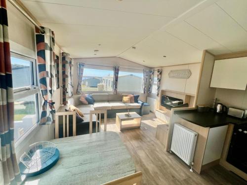 a kitchen and living room with a caravan at Reeva's Retreat at Littlesea Holiday Park, Weymouth in Wyke Regis