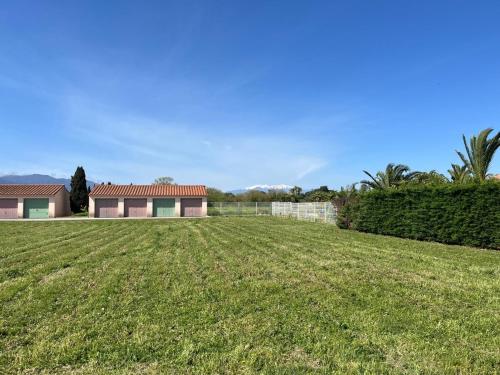 a large grassy field in front of a house at At Anne-Laure and Martine's in Argelès-sur-Mer