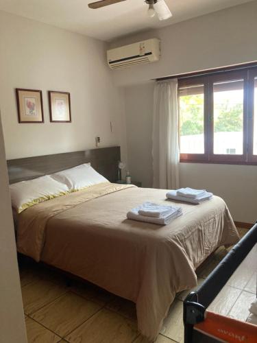 a bedroom with a bed with two towels on it at Ayala Planta Alta in Santa Rosa