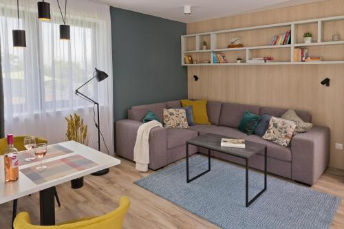 a living room with a couch and a table at Siske Experience 3 önálló apartmannal in Balatonfüred