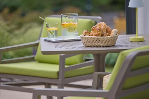 a table with a basket of food and drinks on it at Siske Experience 3 önálló apartmannal in Balatonfüred