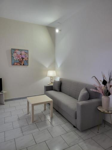 a living room with a couch and a table at Pyrgos Hotel Apartments in Kremasti