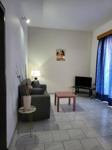 a living room with a couch and a table at Pyrgos Hotel Apartments in Kremasti