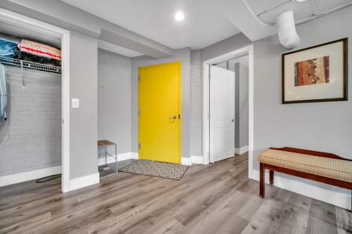 a yellow door in a room with white walls at Cle Suites 3BR 2BA 5 min Walk to Cle Clinic Unit 1 in Cleveland