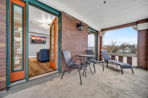 a patio with chairs and a table and windows at Cle Suites 2BR 1BA 5 min Walk to Cle Clinic Unit 4 in Cleveland