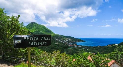a sign that reads petite aise latiniths at Ti Cocon Des Iles, Charming Bungalow Private Spa in Les Anses-dʼArlets