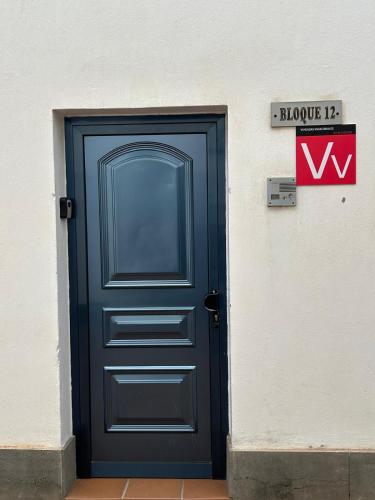 a blue door on the side of a building at Casa Tito in Playa Honda