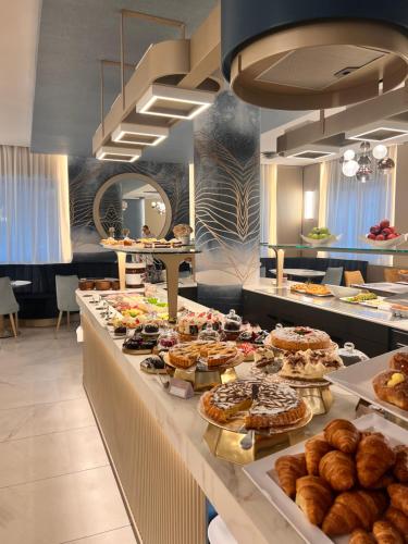 a buffet line with many different types of pastries at Hotel Villa Paola in Rimini