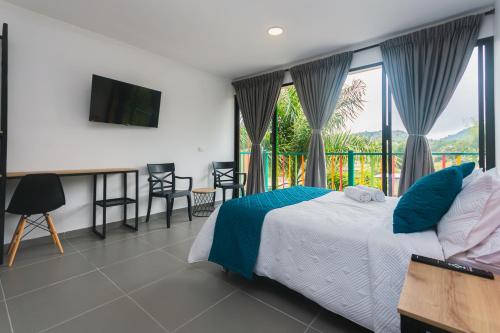 a bedroom with a bed and a balcony at Guatapé Country House Hotel in Guatapé
