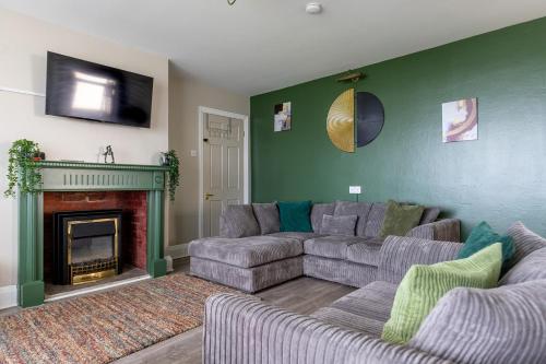 a living room with a couch and a fireplace at BEACHFRONT APARTMENT - Ground Floor Apartment with Sea Views, Next to the Beach, Bridlington, North Yorkshire in Bessingby