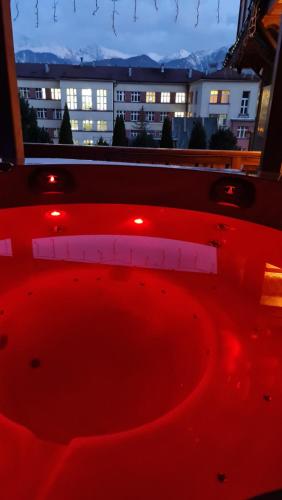 a red object with a view of a building at Villa Fortuna - Regionalne apartamenty & SPA - Sauna, Grill, Jacuzzi z widokiem na Tatry in Zakopane