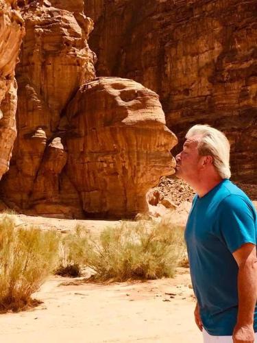 a man standing in front of a canyon at Lowrance luxury camp in Wadi Rum