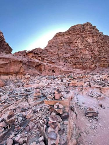a rocky hillside with a mountain in the desert at Lowrance luxury camp in Wadi Rum
