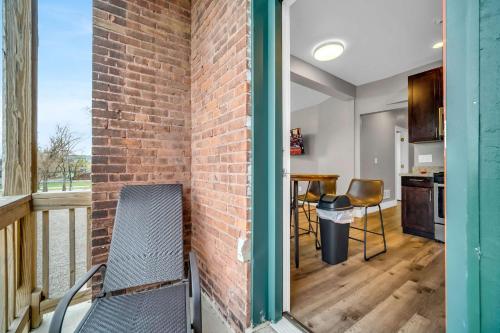 a brick wall next to a balcony with a table and chairs at Cle Suites 1BR 1BA 5 min Walk to Cle Clinic #10 in Cleveland