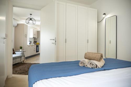 a bedroom with a bed with towels on it at Stella & Rosie - Two Bedroom Apartment's by ELDI in Pieta