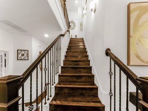 a staircase in a home with white walls at A Homely Getaway in Lewisville