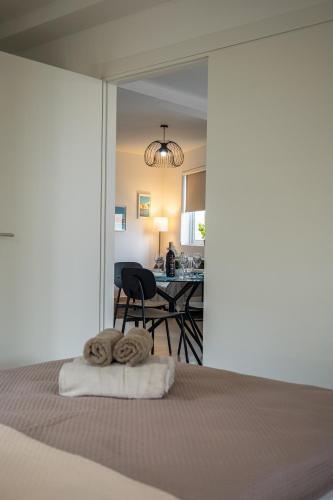 a bedroom with a bed and a dining room at Stella & Rosie - Two Bedroom Apartment's by ELDI in Pieta