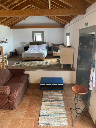 a living room with a bed and a couch at Casa da Lapa in Angra do Heroísmo
