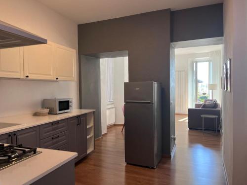 a kitchen with a refrigerator in the middle of a room at Luisa apartment in Lesa